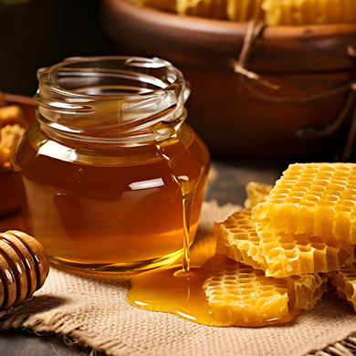 Glass jar of raw honey dripping onto hessian beside golden honeycomb and a wooden dipper
