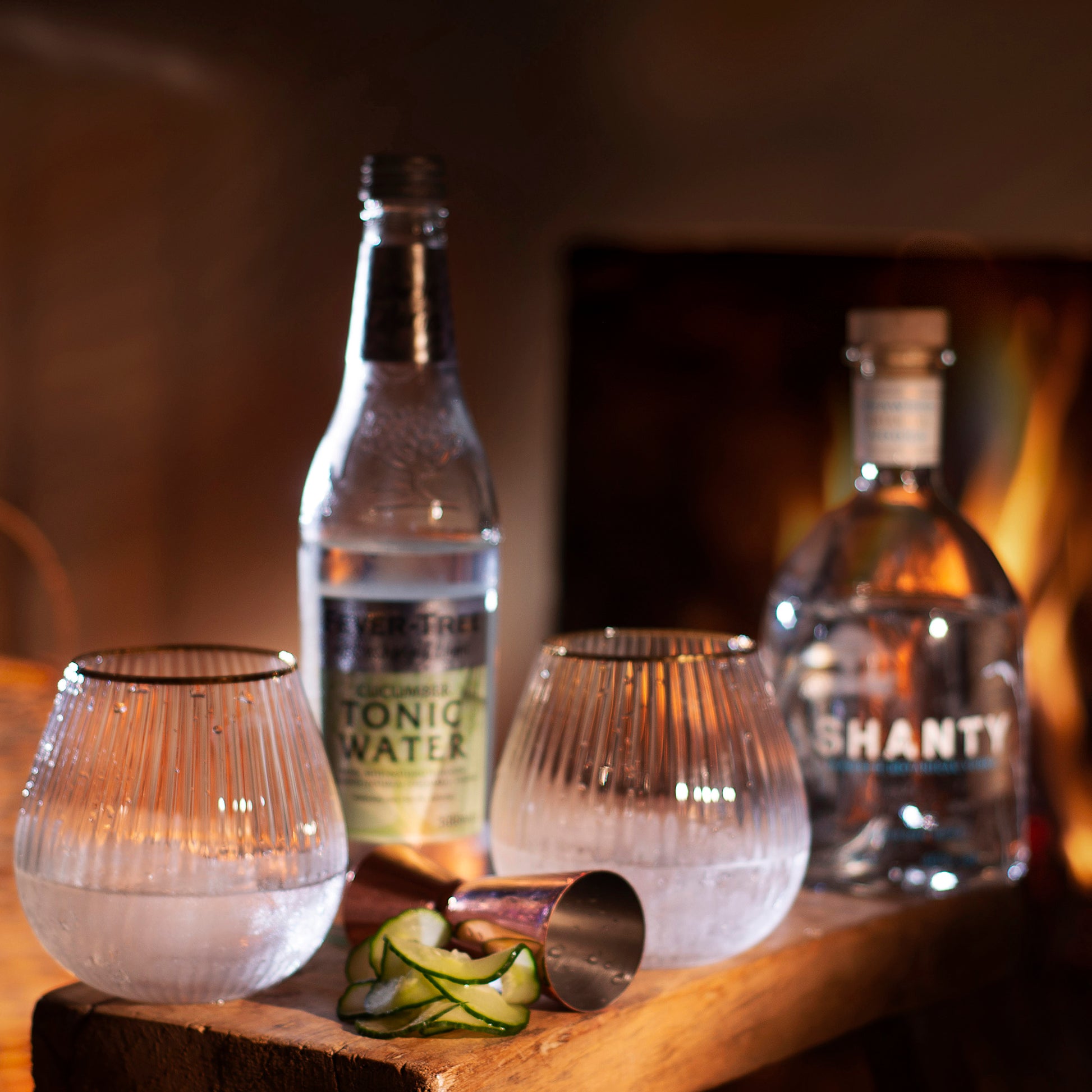 Shanty Spirit Seaweed Botanical Vodka Sea Cucumber Cocktail with open fire background